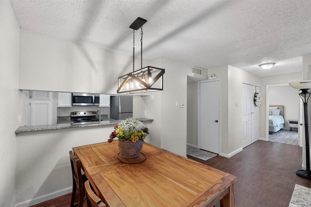 9611 Walnut Street, Unit 1105 Dallas, TX 75081 - Photo 9 of 24 a kitchen with a table and chairs in it