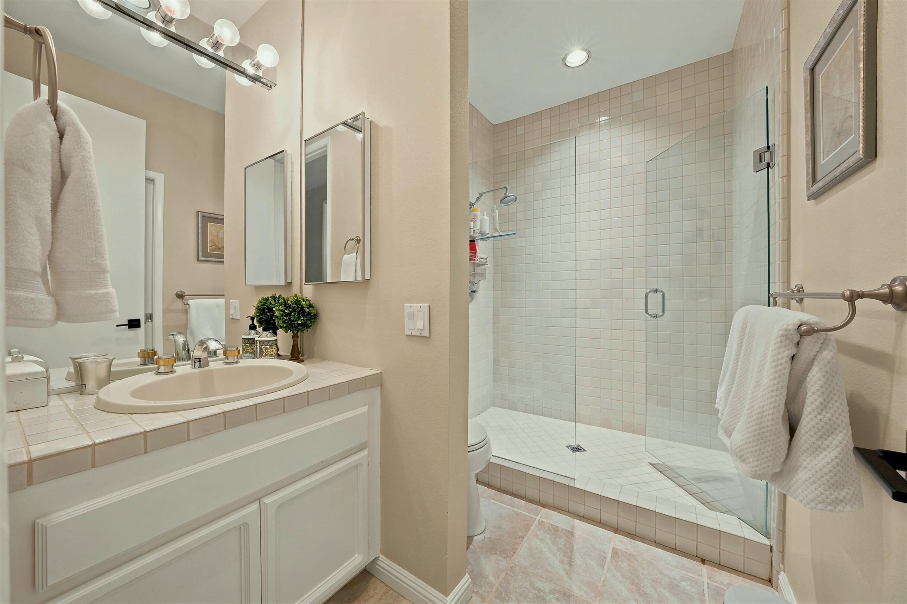 138 Lakeshore Drive Rancho Mirage, CA 92270 - Photo 23 of 30 a bathroom with a sink a toilet and shower