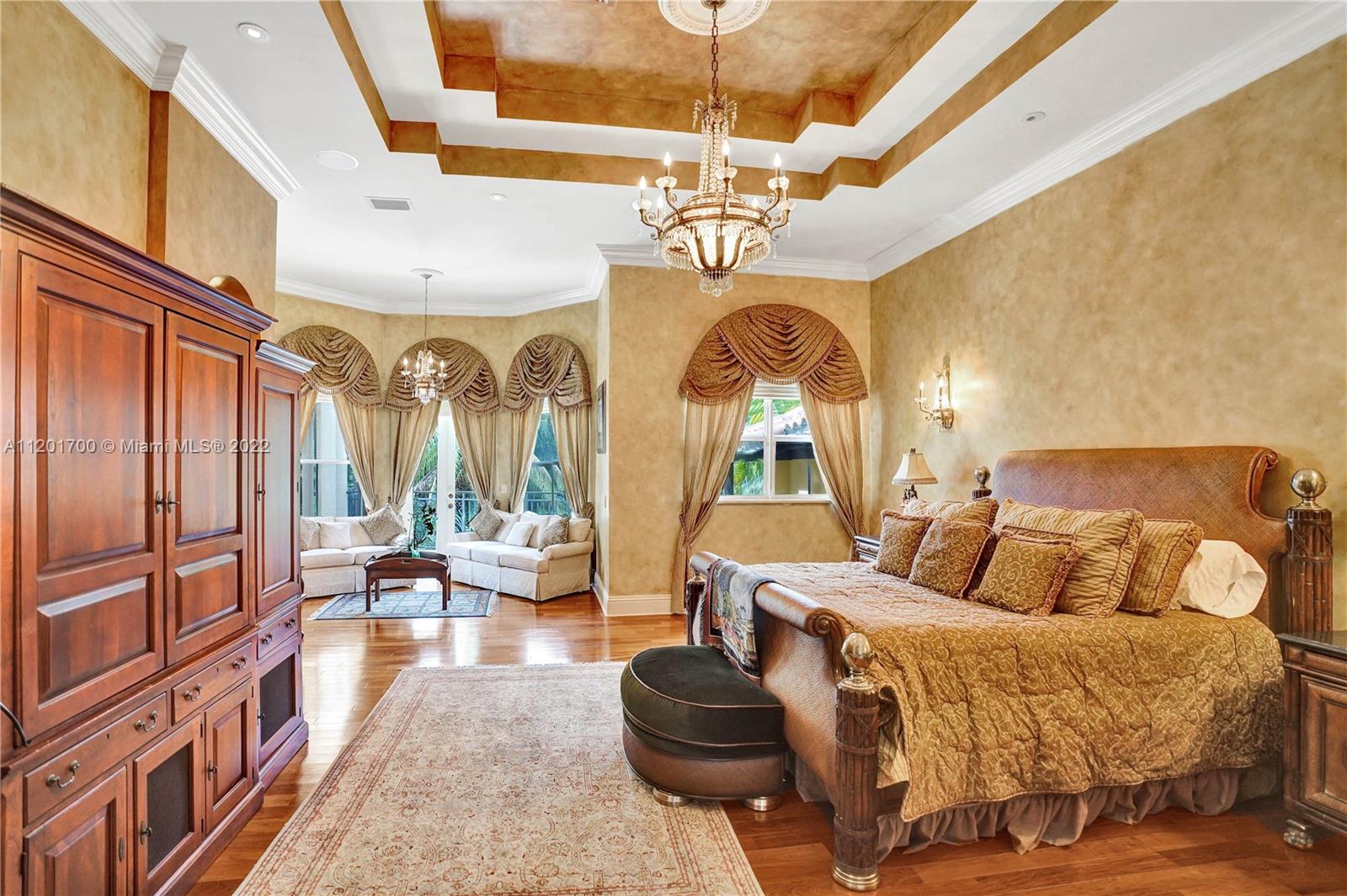 3460 Paddock Road Weston, FL 33331 - Photo 25 of 62 a living room with furniture a chandelier and a large window