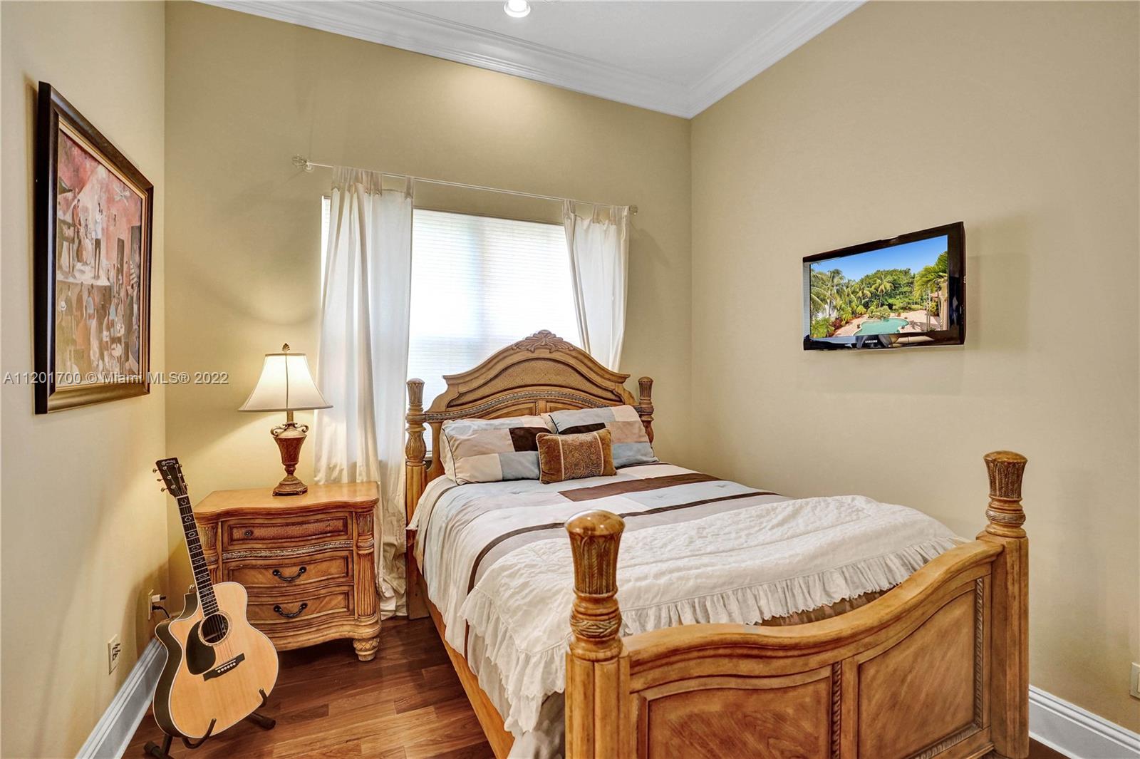 3460 Paddock Road Weston, FL 33331 - Photo 35 of 62 a bedroom with a bed and wooden floor