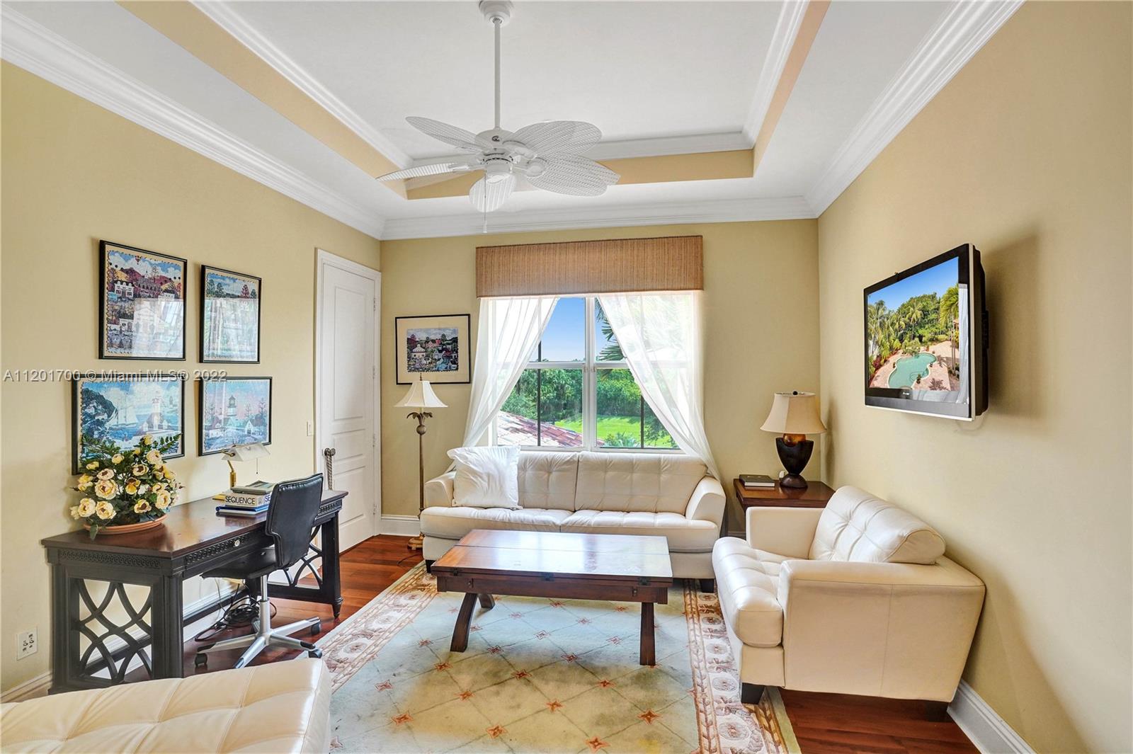 3460 Paddock Road Weston, FL 33331 - Photo 39 of 62 a living room with furniture a table and a window