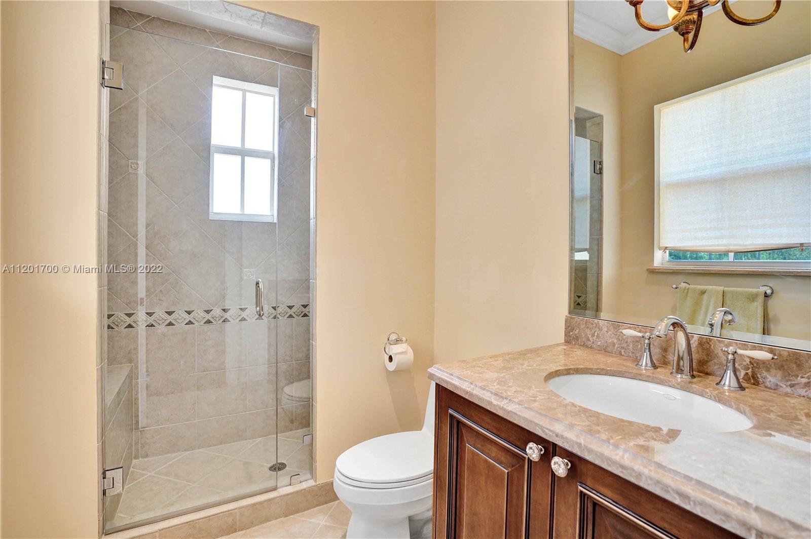 3460 Paddock Road Weston, FL 33331 - Photo 40 of 62 a bathroom with a granite countertop sink a toilet and shower
