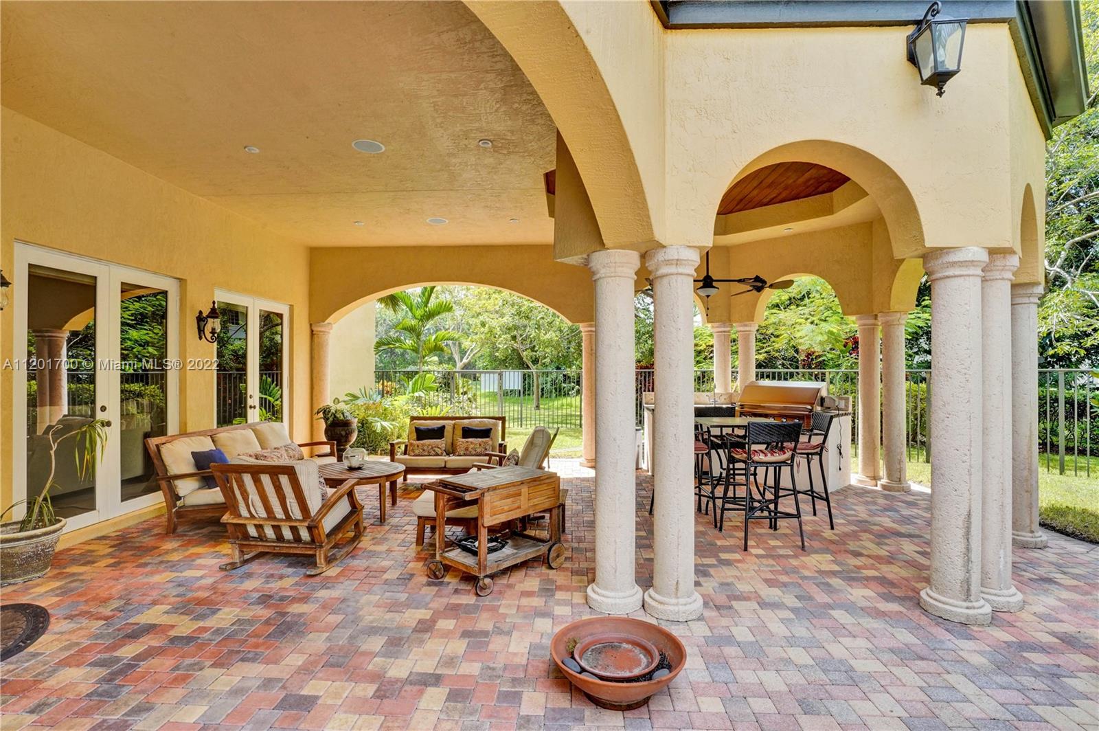 3460 Paddock Road Weston, FL 33331 - Photo 48 of 62 a living room with furniture a window and a table