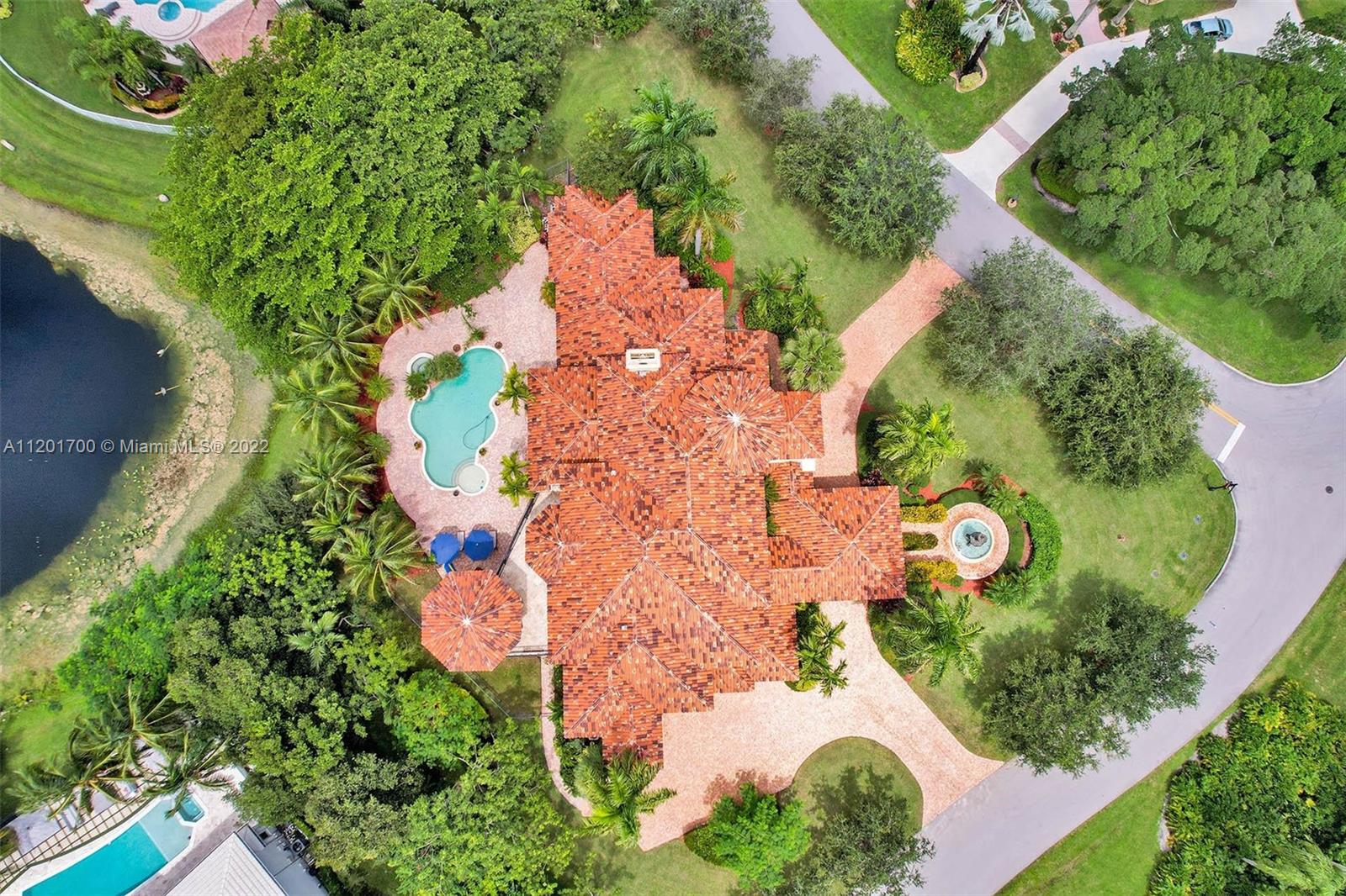 3460 Paddock Road Weston, FL 33331 - Photo 58 of 62 an aerial view of a house with a yard and plants