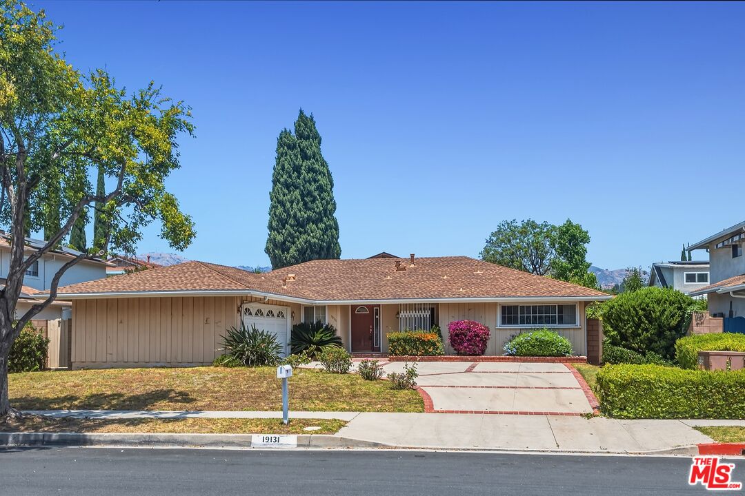 19131 Tulsa Street Porter Ranch, CA 91326 - Photo 2 of 43 a front view of a house with garden