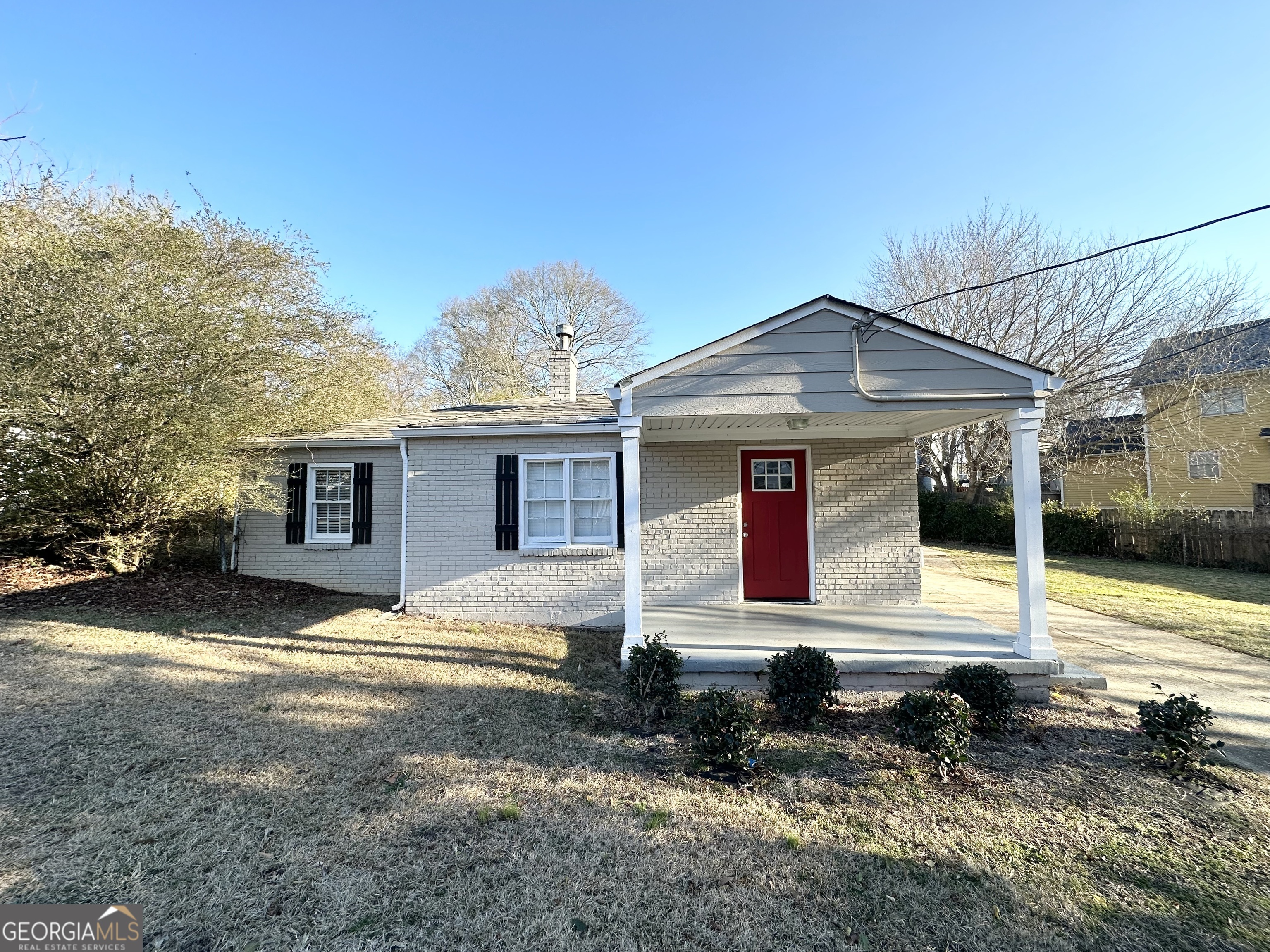 1876 Flat Shoals Road Southeast Atlanta, GA 30316 - Photo 2 of 11 a front view of a house with garden