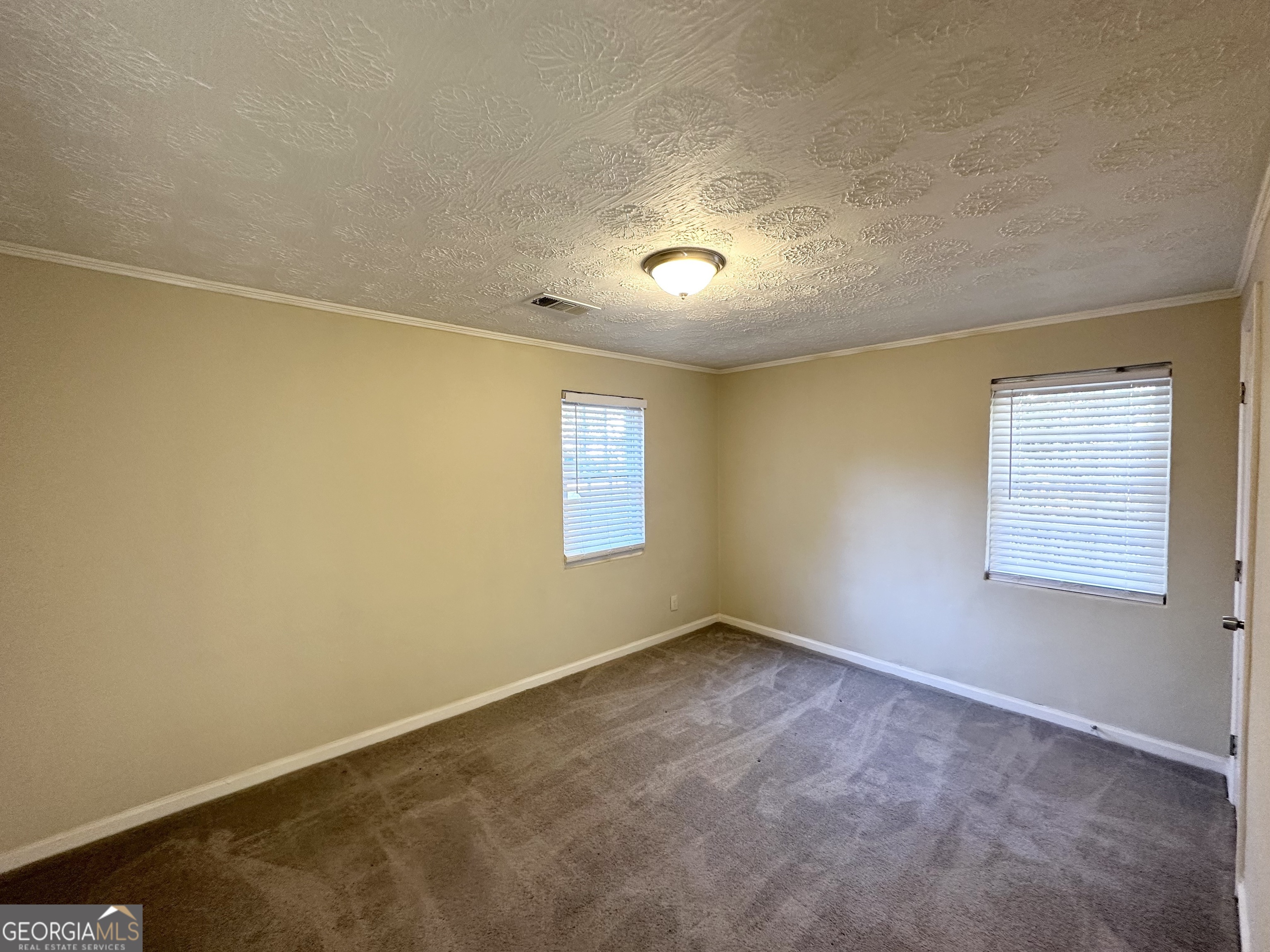 1876 Flat Shoals Road Southeast Atlanta, GA 30316 - Photo 7 of 11 an empty room with a empty space and windows