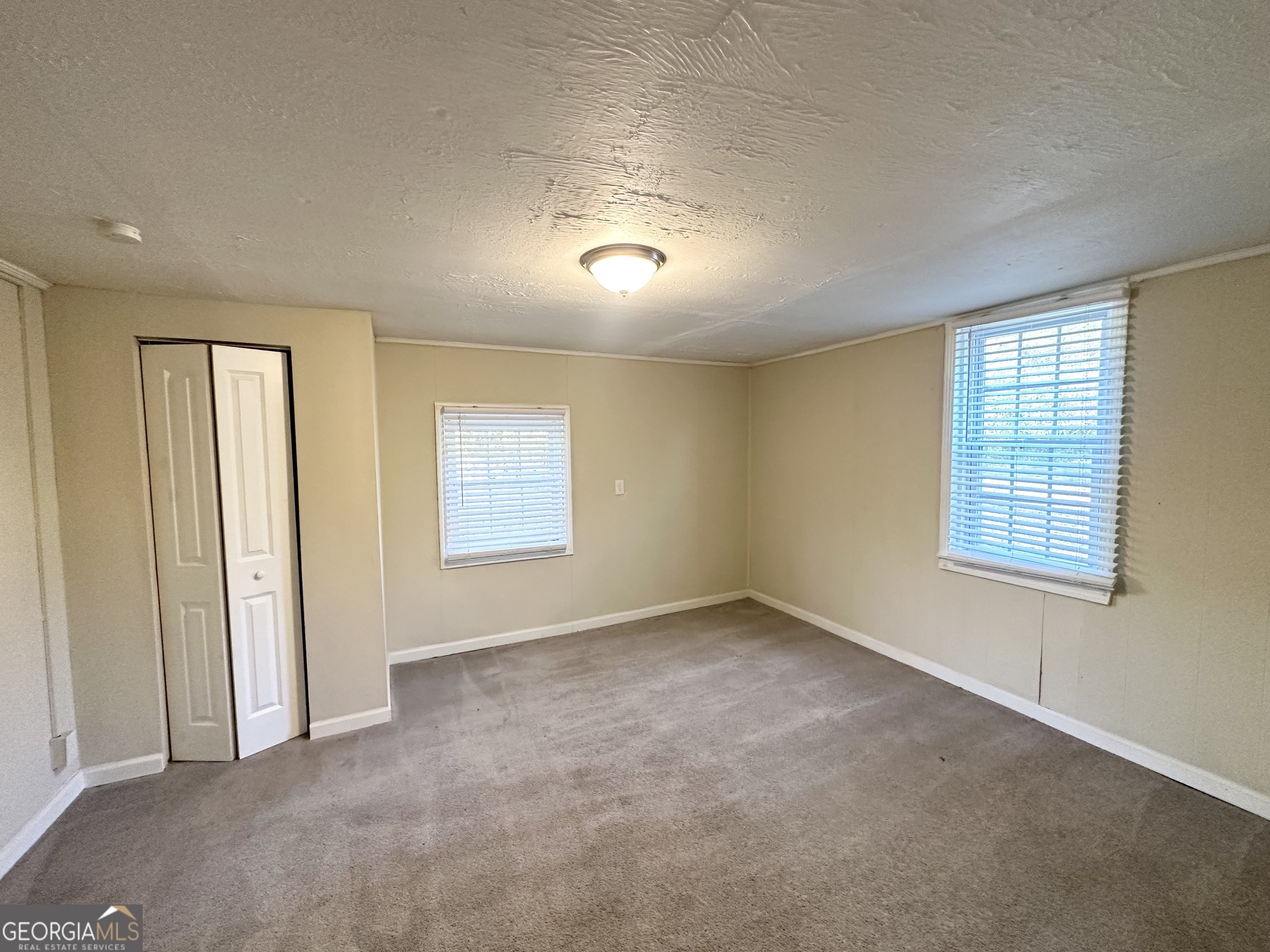 1876 Flat Shoals Road Southeast Atlanta, GA 30316 - Photo 10 of 11 an empty room with windows