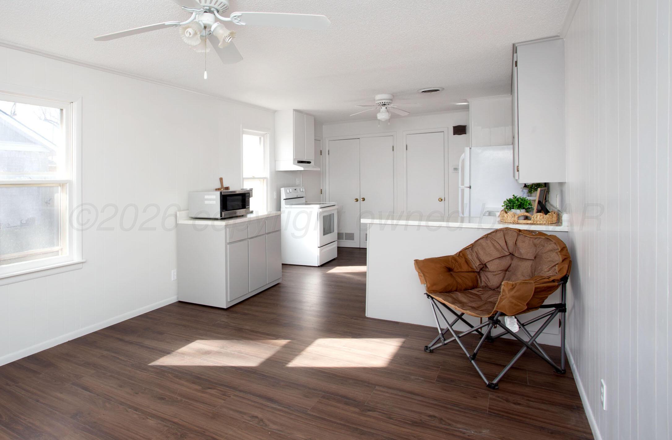 1107 Main Street Panhandle, TX 79068 - Photo 12 of 24 a living room with furniture and a wooden floor
