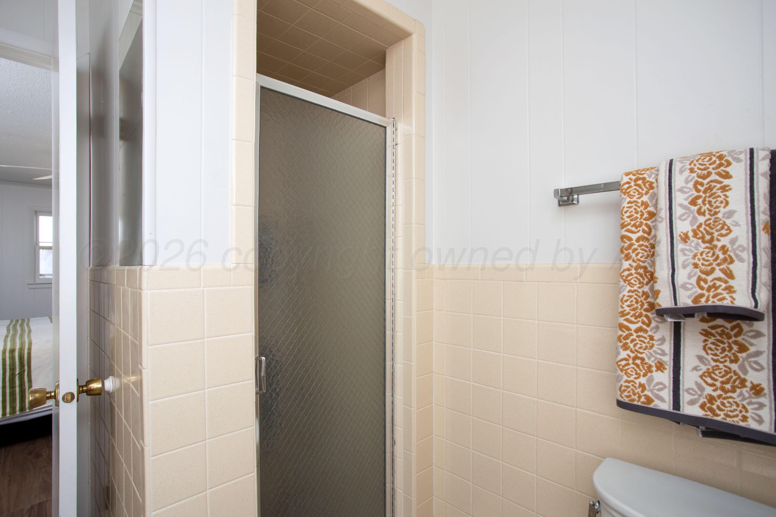 1107 Main Street Panhandle, TX 79068 - Photo 20 of 24 a bathroom with a toilet and shower