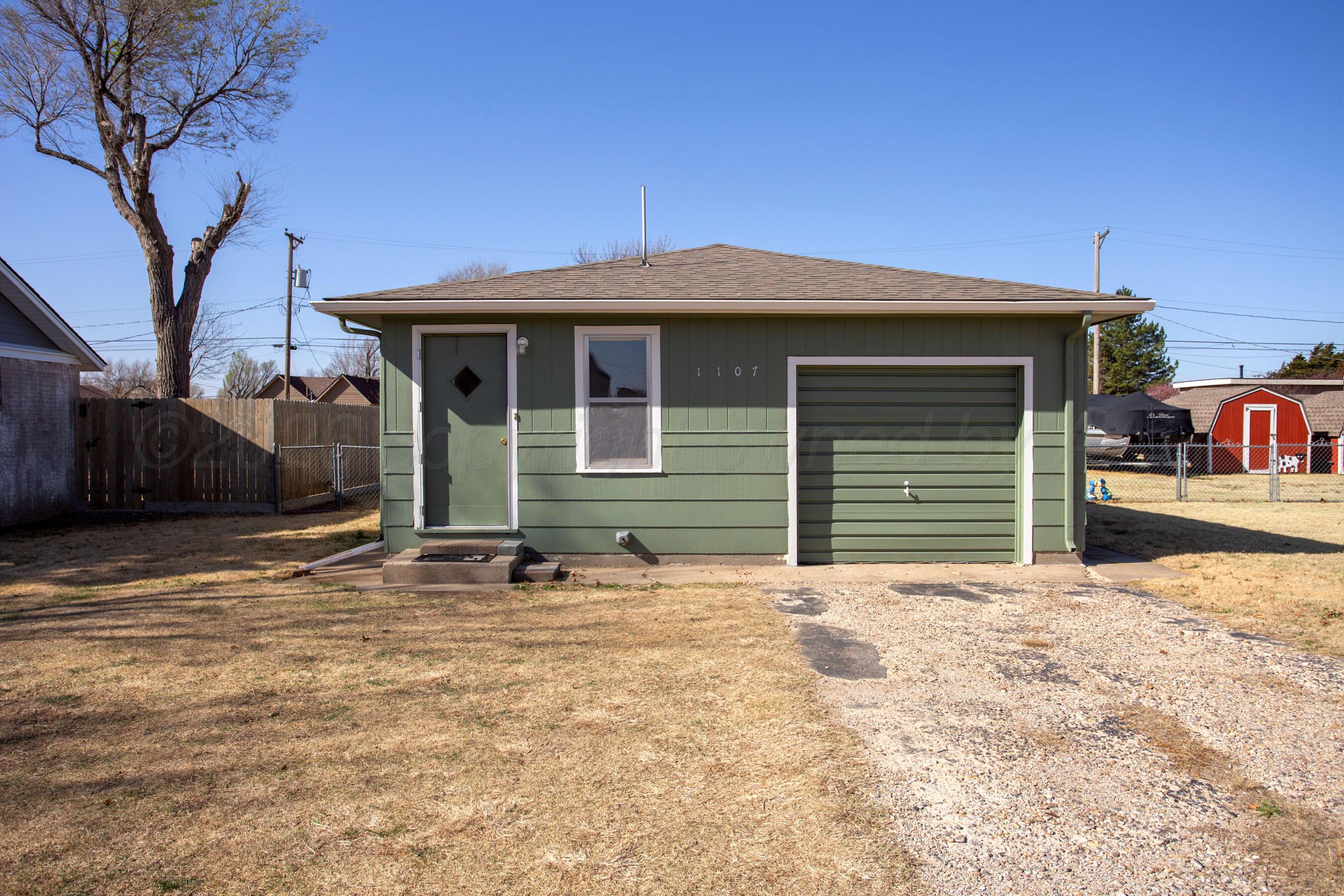 1107 Main Street Panhandle, TX 79068 - Photo 2 of 24 a front view of a house with a tree