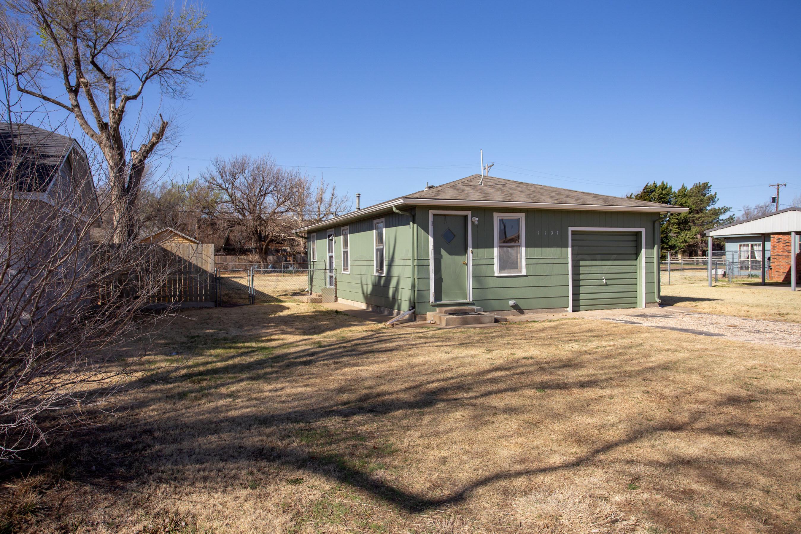 1107 Main Street Panhandle, TX 79068 - Photo 3 of 24 a front view of a house with a garden
