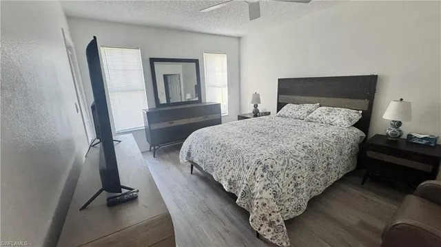 a bedroom with bed and wooden floor