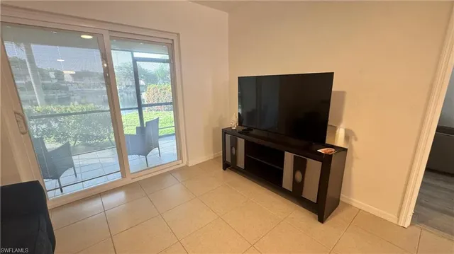 a living room with furniture and flat screen tv