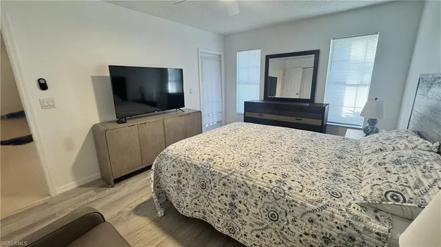a bedroom with a bed and a flat screen television