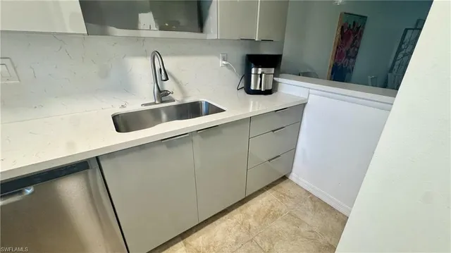 a kitchen with a sink and a refrigerator