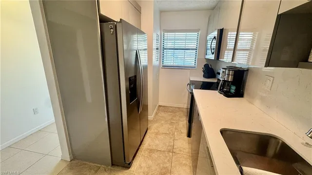 a kitchen with stainless steel appliances a refrigerator and a counter