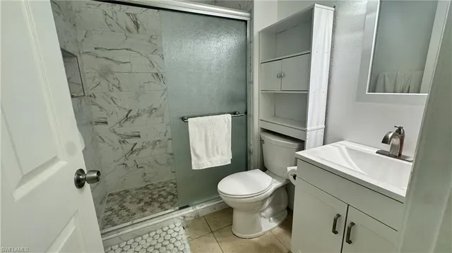 a white toilet sitting next to a bathroom sink