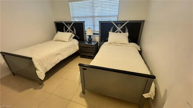 a bedroom with bed and window