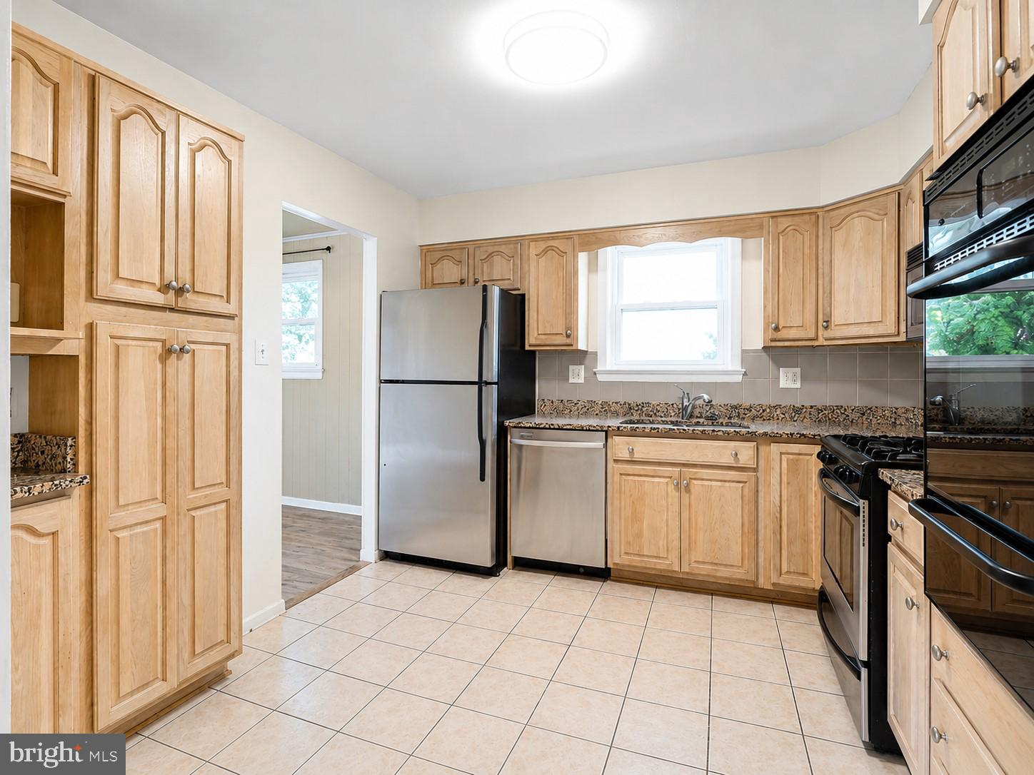 11312 Old Fort Road Fort Washington, MD 20744 - Photo 3 of 13 a kitchen with a refrigerator a stove a sink and a window