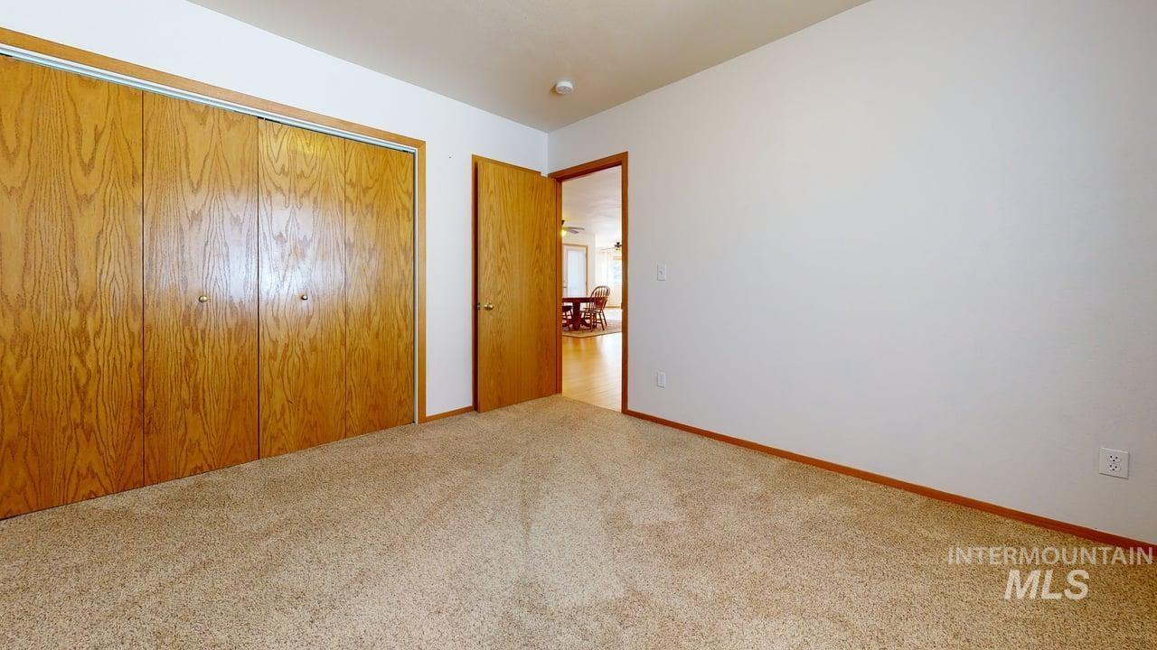 2794 9th Avenue Clarkston, WA 99403 - Photo 23 of 34 Unfurnished bedroom featuring a closet and light carpet