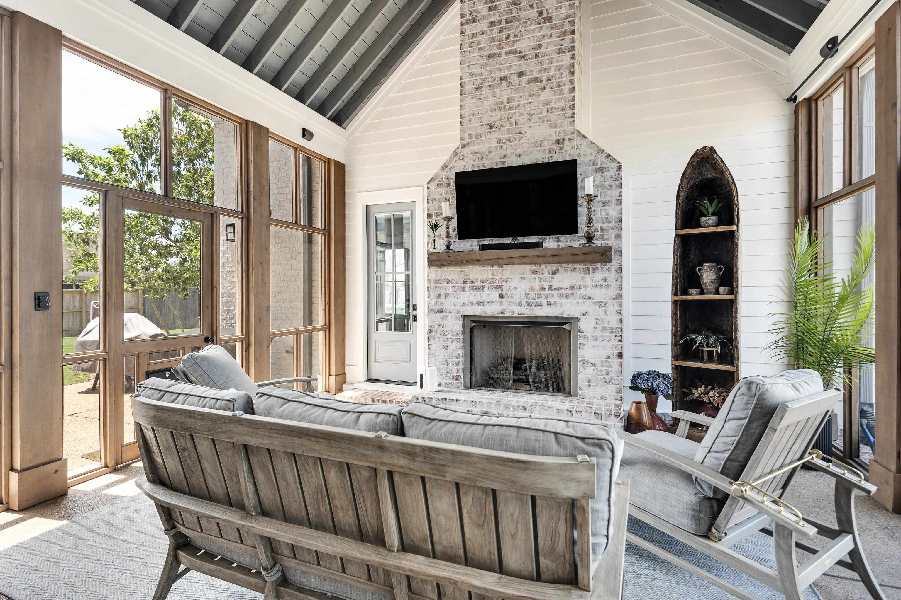 100 Sunflower View Road Piperton, TN 38017 - Photo 28 of 29 Vaulted ceiling sunroom featuring exposed rafters, a whitewashed brick fireplace with a wood mantle, and floor-to-ceiling windows