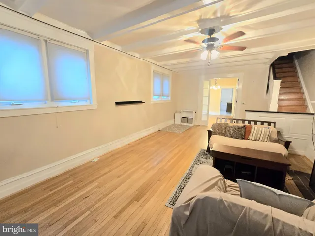 a spacious bedroom with a bed a couch and window