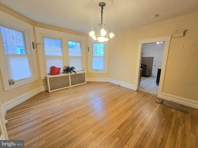 a view of a room with wooden floor and door