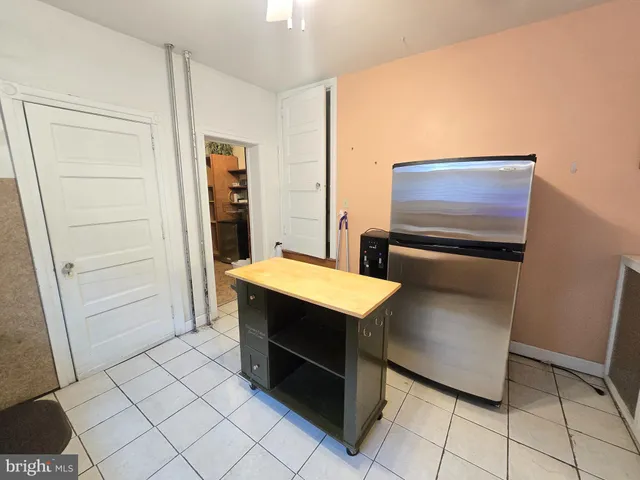 a room with washing machine and storage