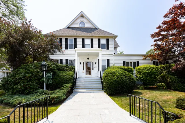 a front view of a house with a garden