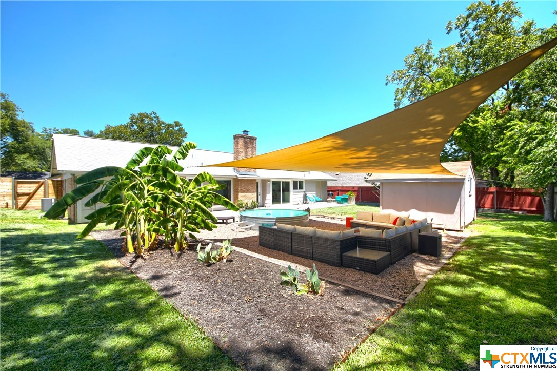 a view of house with backyard