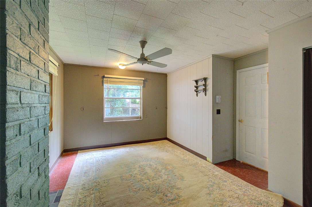 5064 Keowee School Road Seneca, SC 29672 - Photo 39 of 49 This living area features a classic brick fireplace and a welcoming front door.