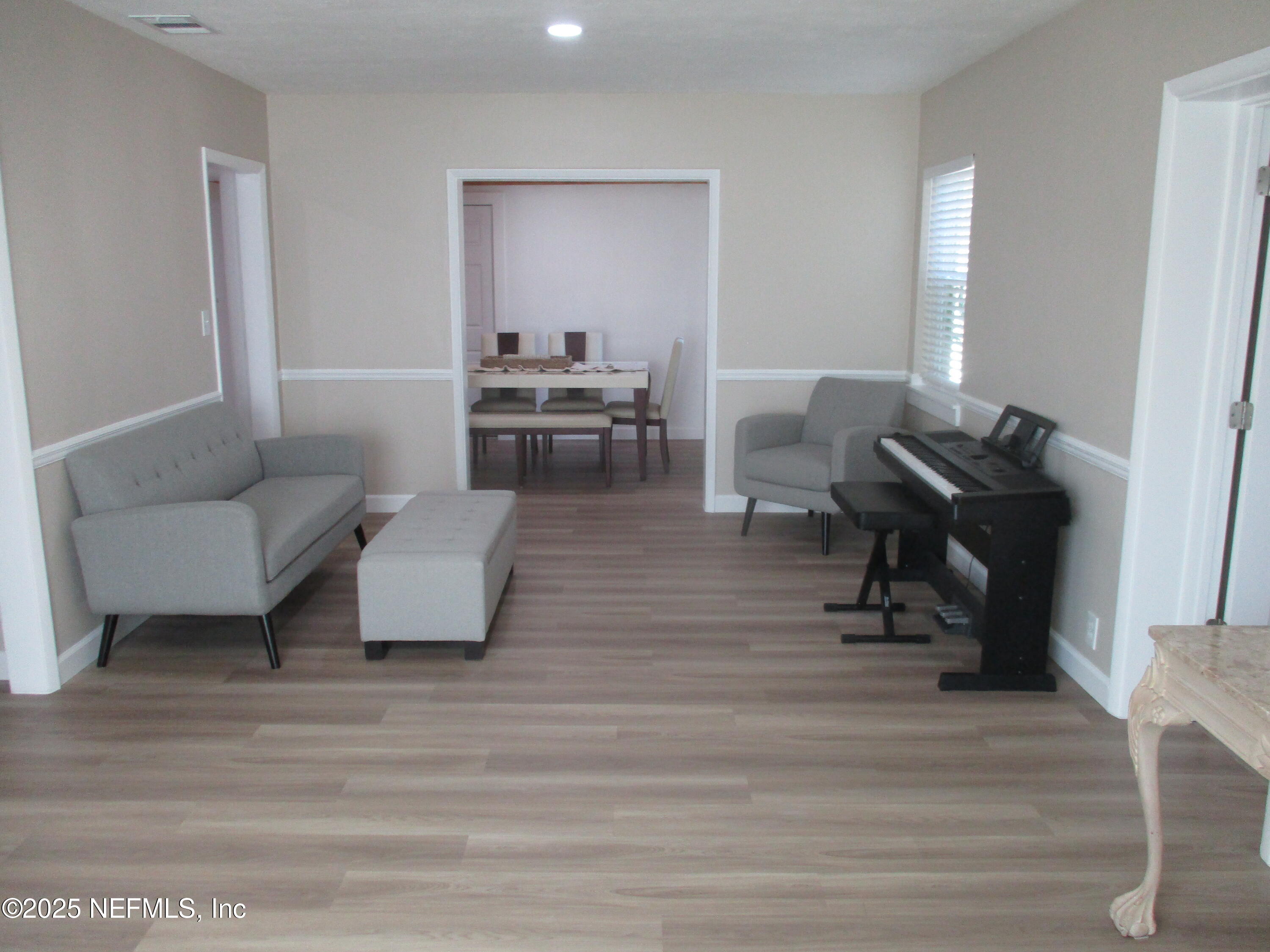 6114 Stetson Road Jacksonville, FL 32217 - Photo 2 of 23 a living room with furniture and a wooden floor