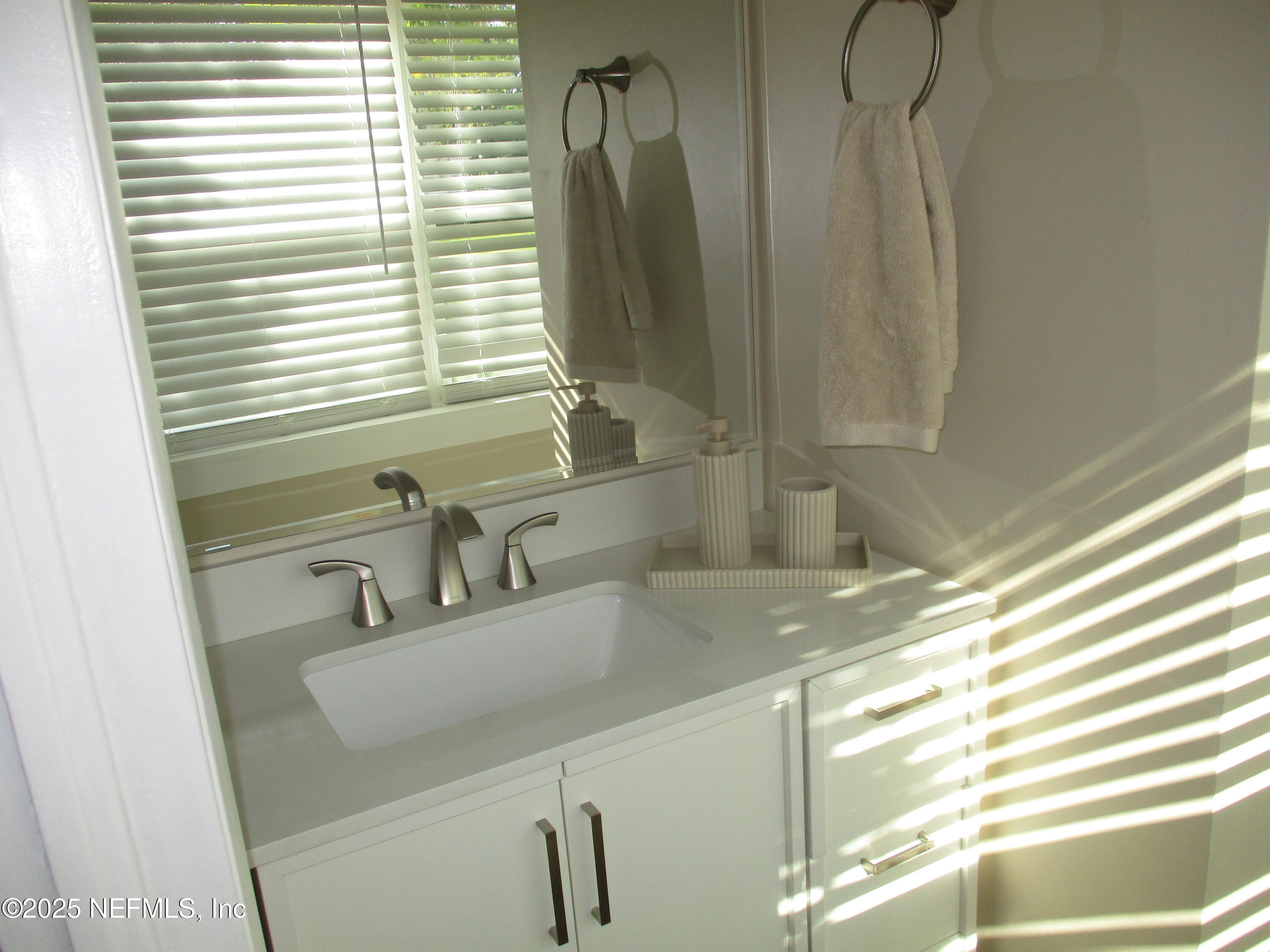 6114 Stetson Road Jacksonville, FL 32217 - Photo 9 of 23 a bathroom with a sink and a large mirror