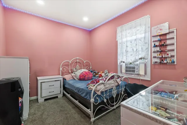 a bedroom with furniture and a baby crib