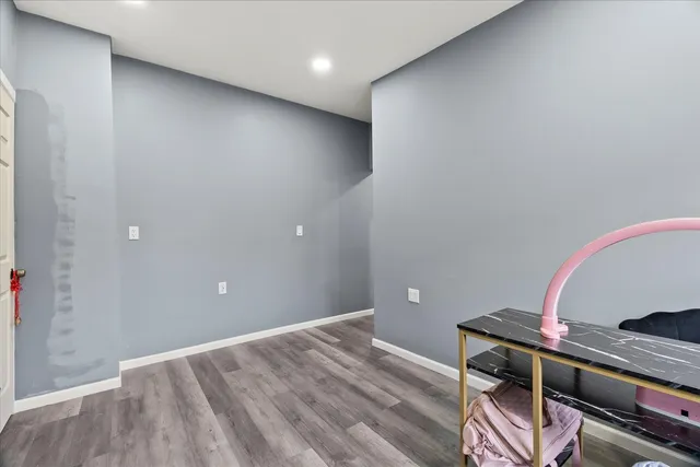 a view of room with wooden floor