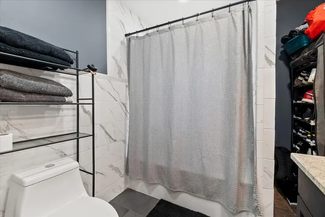 a bathroom with a shower curtain and sink