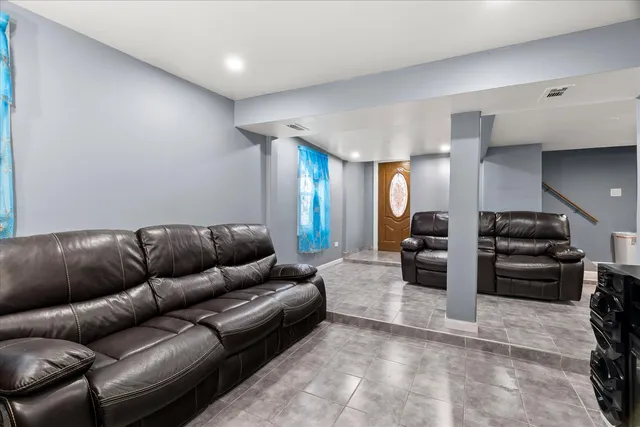 a living room with furniture and a piano