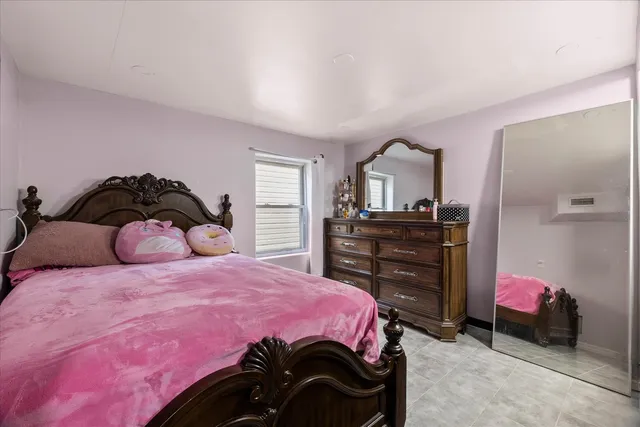 a bedroom with a bed and a dresser