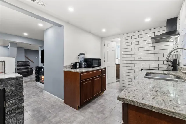 a kitchen with a sink and a stove top oven