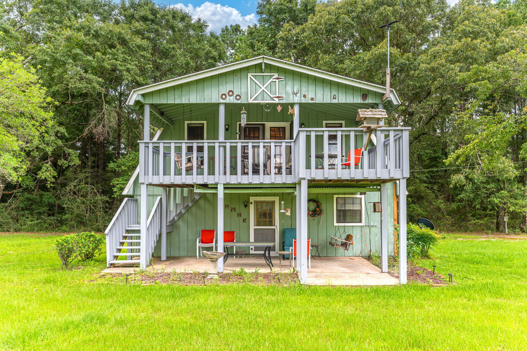 a front view of a house with a yard table and chairs