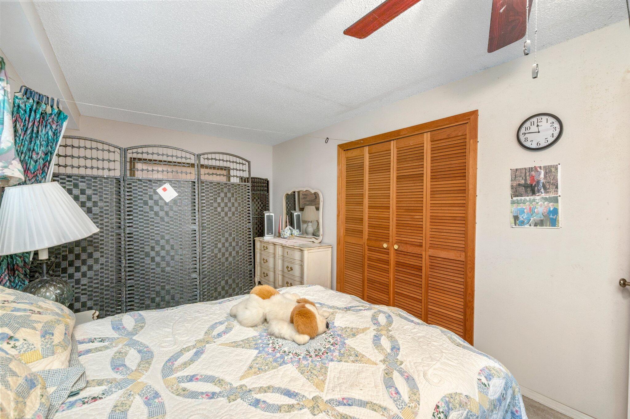 410 Kilpatrick Road Florala, AL 36442 - Photo 15 of 60 a bedroom with a bed and a lamp on the dresser