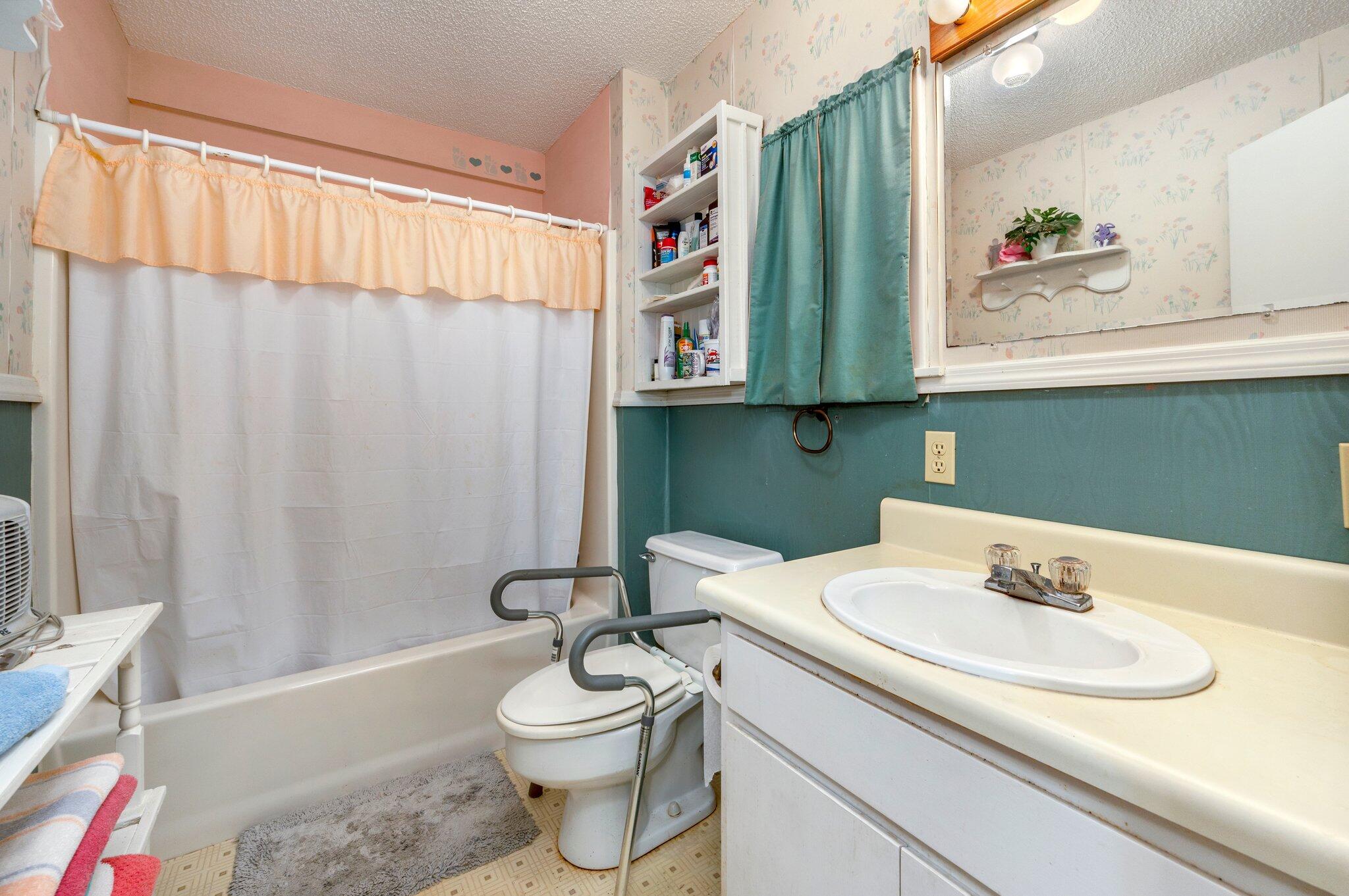 410 Kilpatrick Road Florala, AL 36442 - Photo 22 of 60 a bathroom with a sink a toilet and shower curtain
