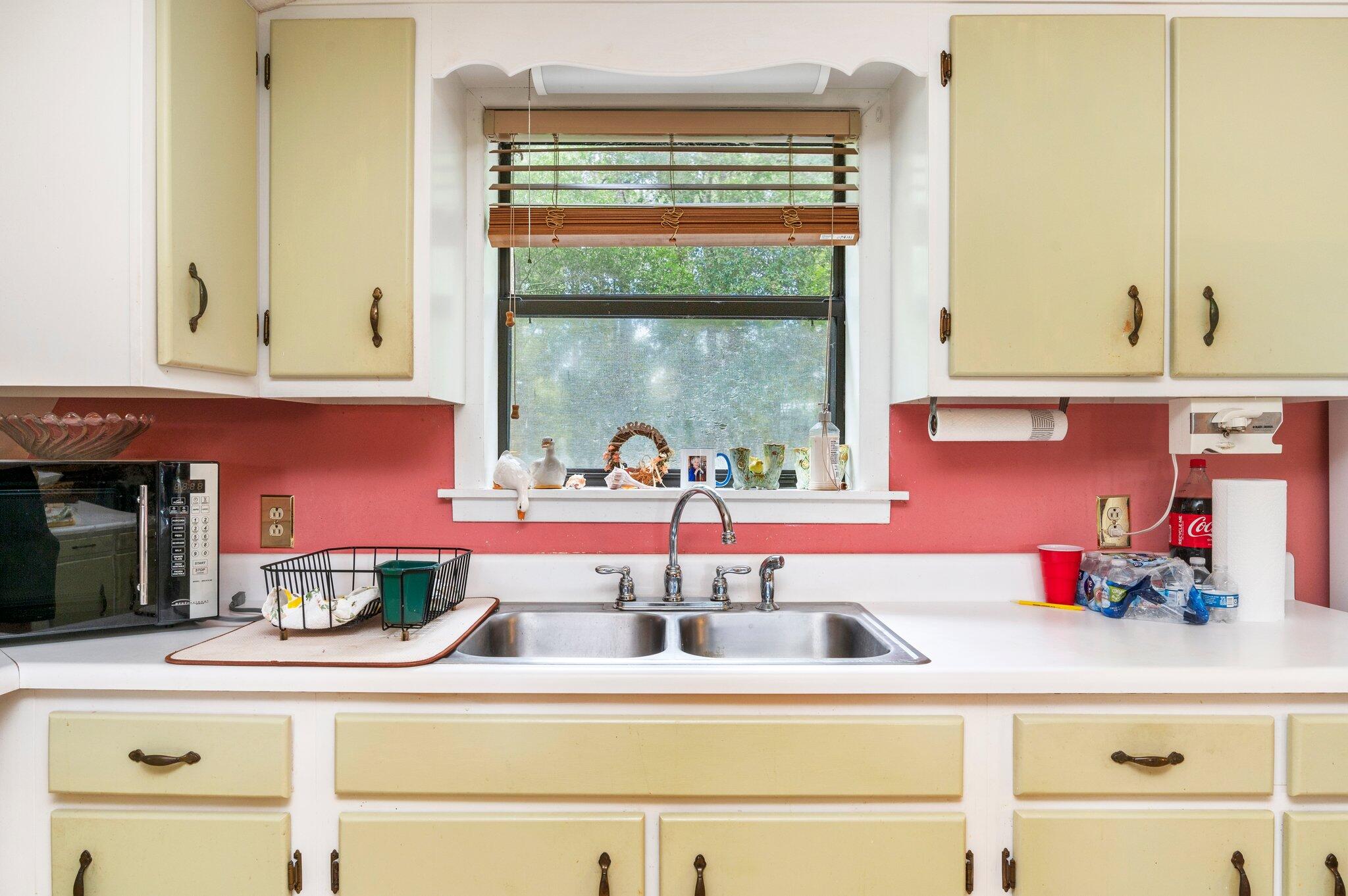 410 Kilpatrick Road Florala, AL 36442 - Photo 5 of 60 a kitchen with a stove and a white cabinets