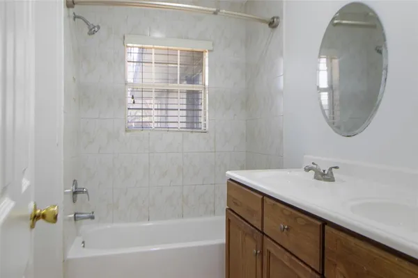 a bathroom with a sink a bathtub and a mirror