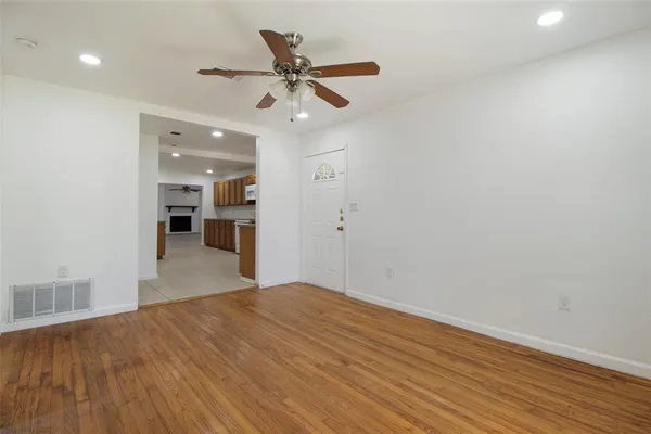 a view of a livingroom with a kitchen counter tops and wooden floor