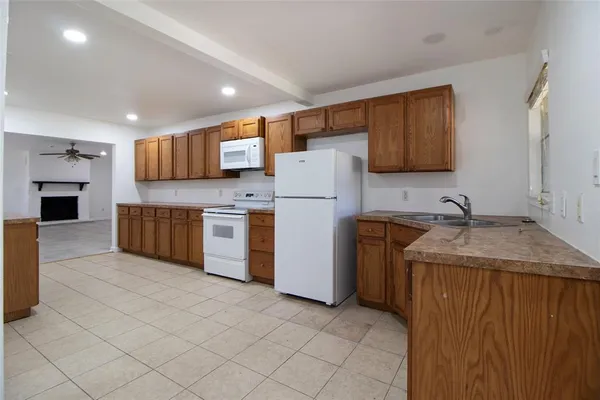 a kitchen with a sink a stove and a refrigerator