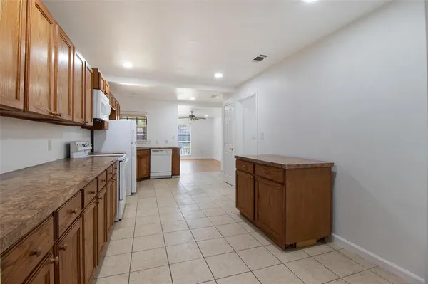 a kitchen with stainless steel appliances granite countertop a sink counter space and cabinets