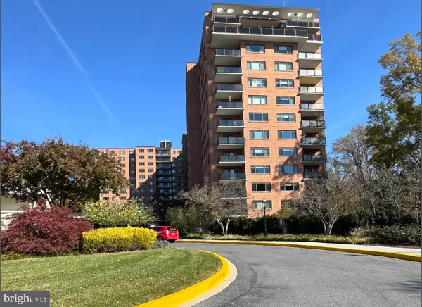 a front view of a multi story building with yard