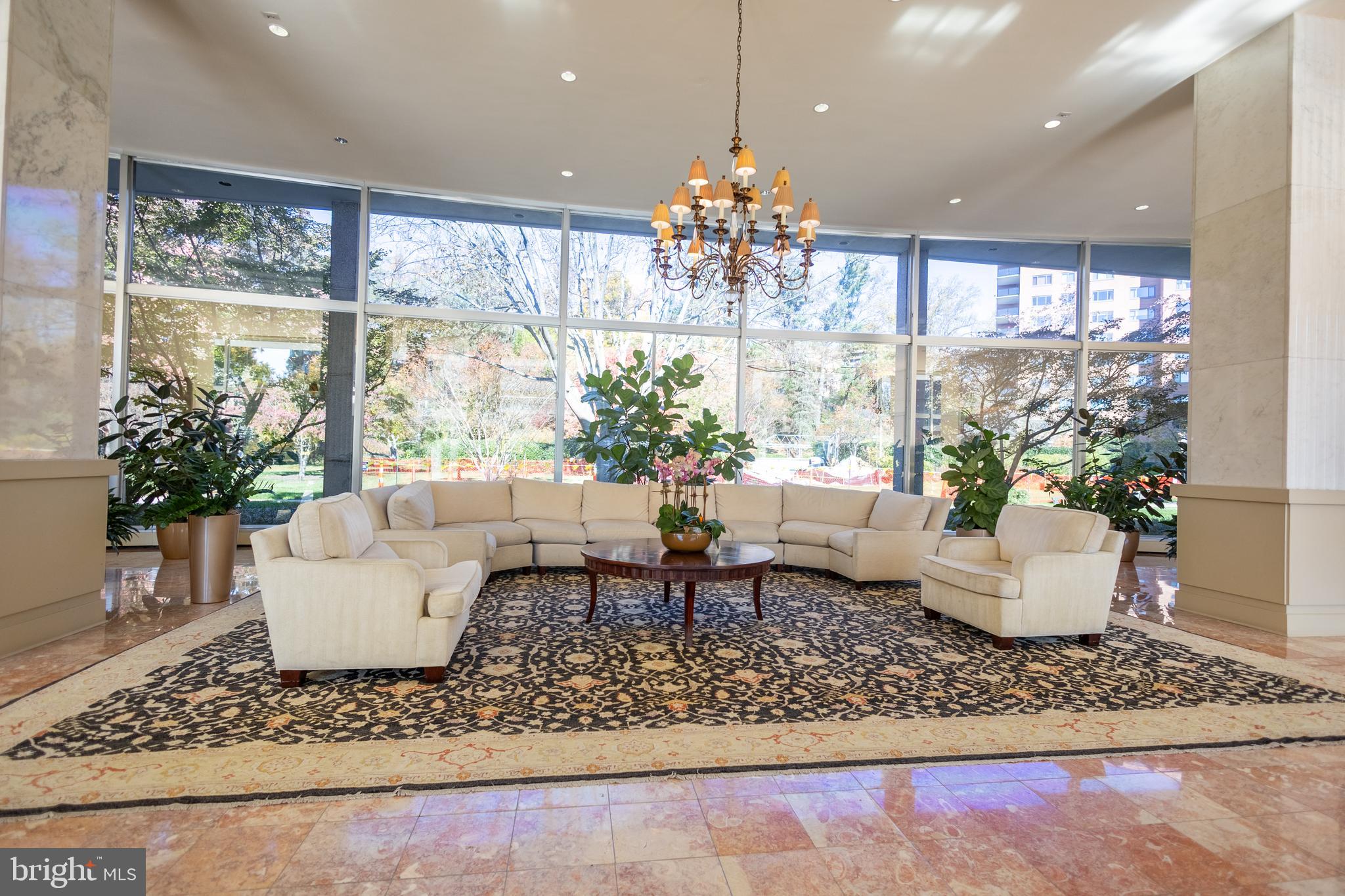 4201 Cathedral Avenue Northwest, Unit 1219E Washington, DC 20016 - Photo 11 of 20 a living room with furniture and a chandelier